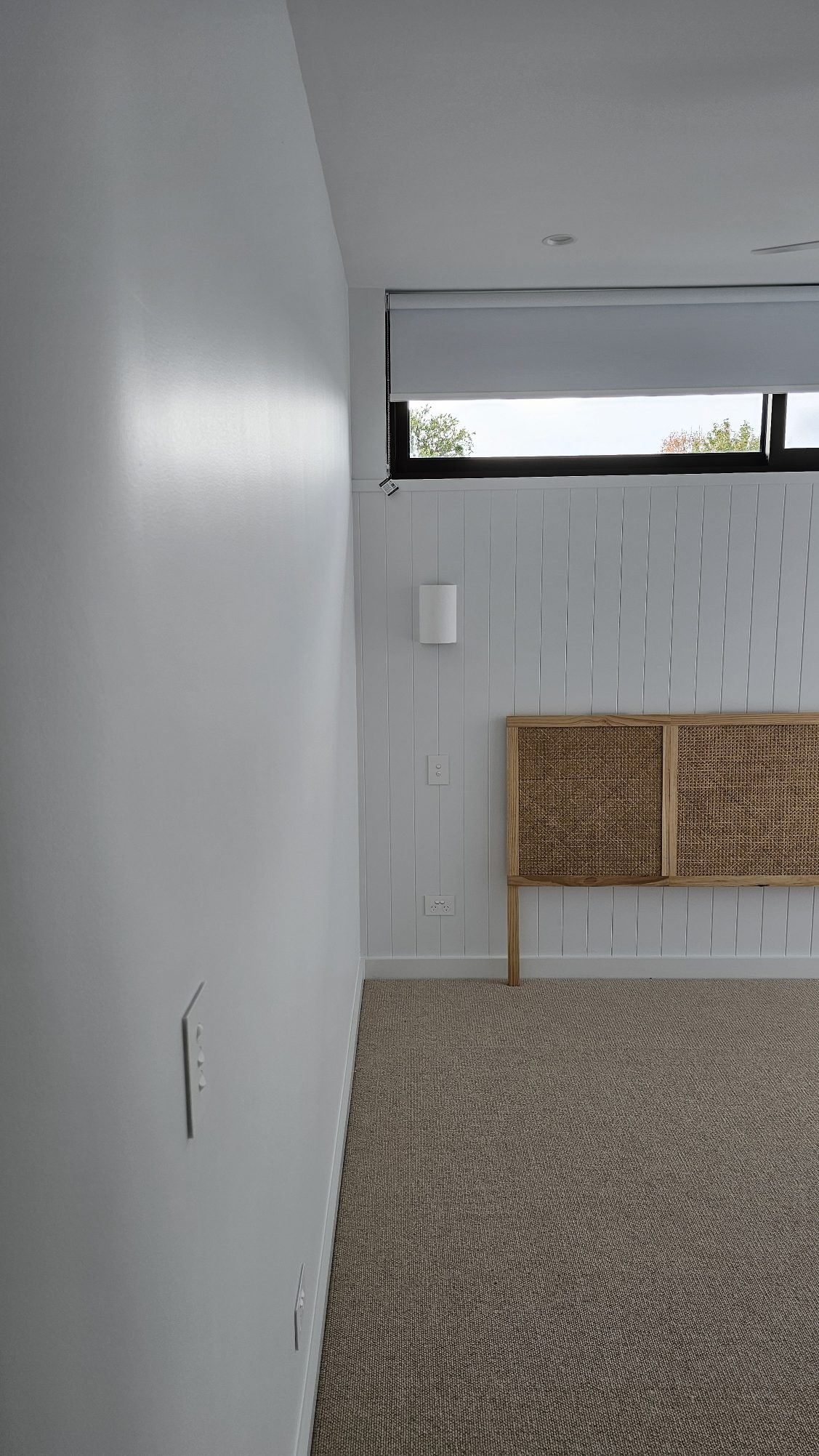 Master bedroom with a bed head laying on one of the walls. Walls are painted in Dulux Lexicon quarter strength and ceilings painting in flat white.