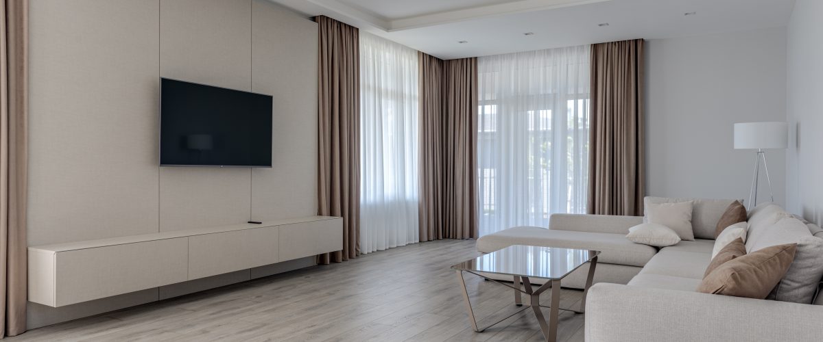 Lounge area with a soft cream lounge and along with a tv and tv unit. Walls are painted in Dulux Feather soft full strength and ceilings are flat white.